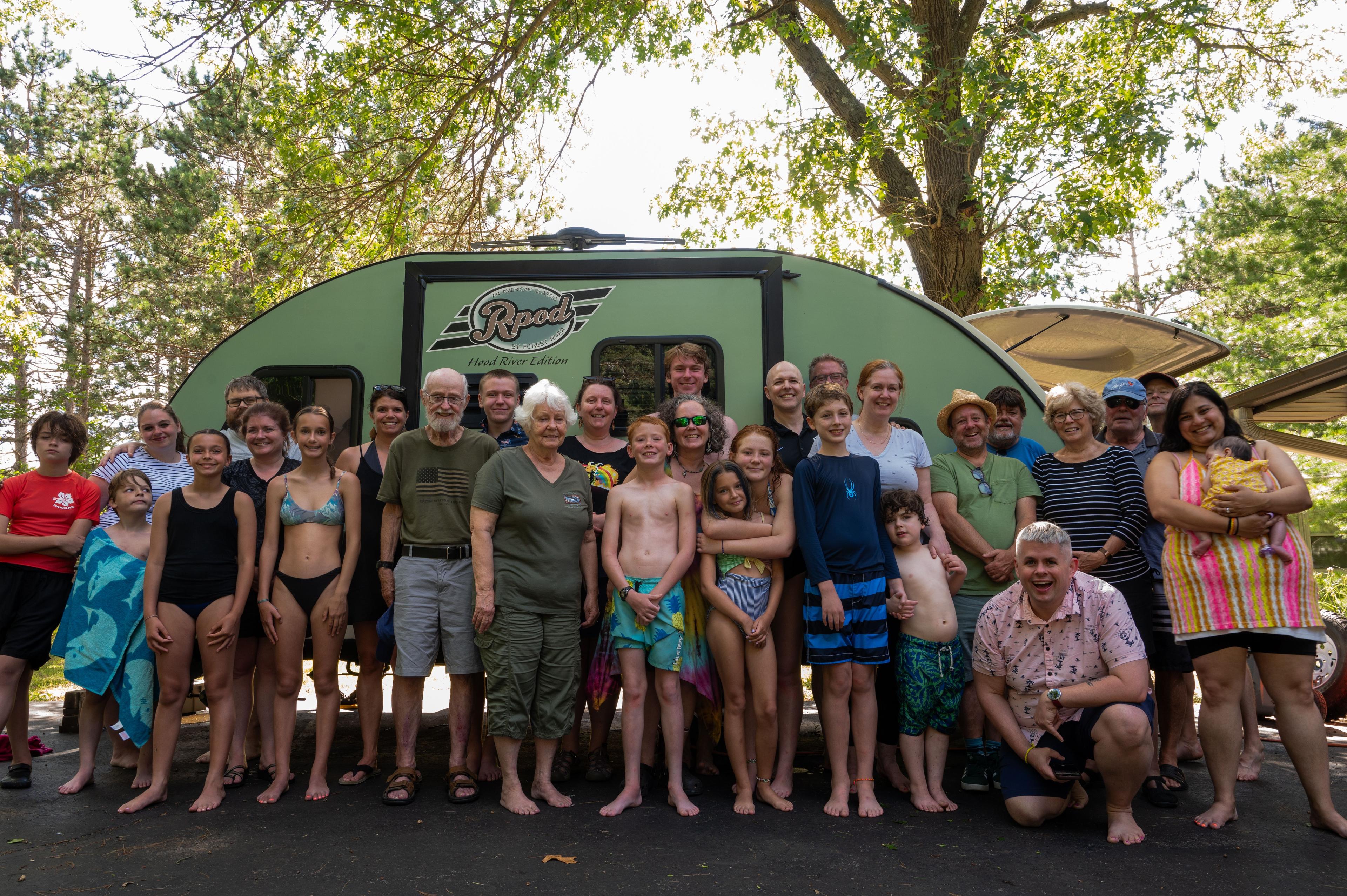 A group photo, 30 people, 3 different generations, all family in front of a camper