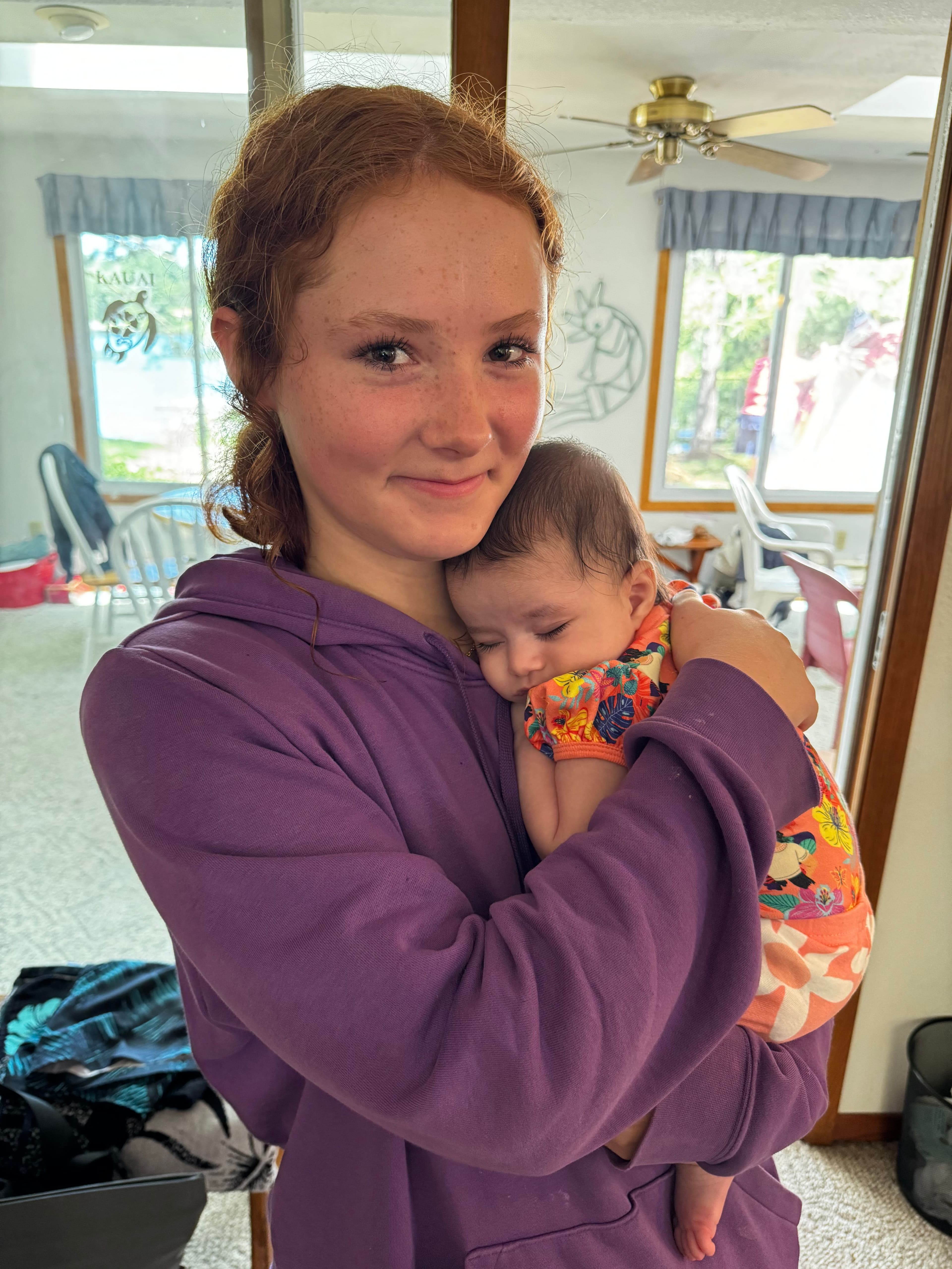 a woman holding a small baby